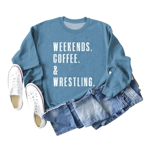 Flat lay of blue crewneck sweatshirt with white typography and denim jeans styling