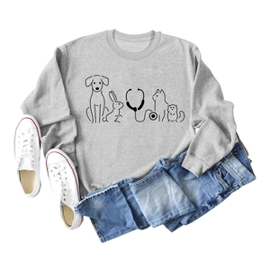 Flat lay of grey crewneck sweatshirt with pet themed line art and medical stethoscope