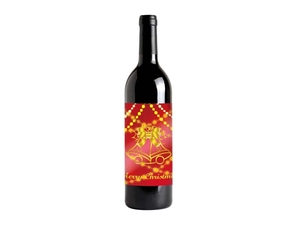 Close-up of luxury red Christmas wine bottle label with gold foil bells and text