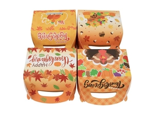 Macro view of four Thanksgiving gift boxes with turkey and pumpkin prints