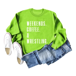 Detailed flat lay of a bright green crewneck sweatshirt with white printed lettering