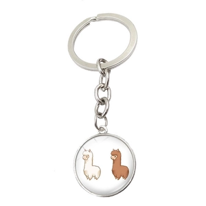 Detail of a silver metal keychain with a round alpaca glass cabochon pendant