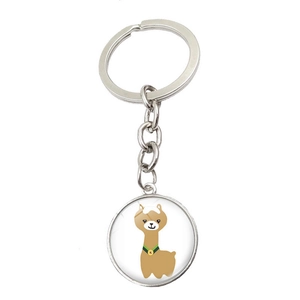 Round silver keychain featuring a cute cartoon alpaca illustration on white background