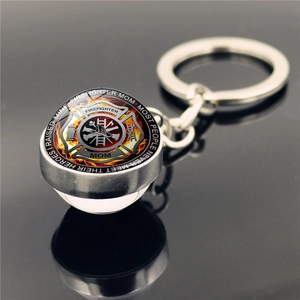 Close-up of firefighter mom keychain with maltese cross and glass dome pendant