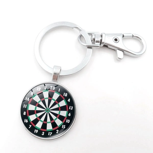 Detail of dartboard keychain with silver clasp and vintage glass dome pendant artwork