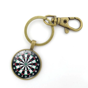 Detailed close-up of retro bronze dartboard pendant with glass dome and lobster clasp