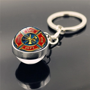 Macro shot of silver metal keychain with glass dome featuring the Fire Dept emblem