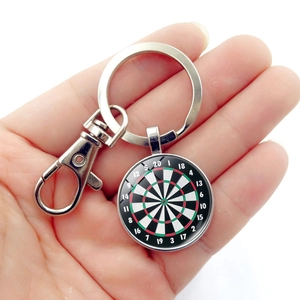 Close-up of a dartboard keychain with glass dome and vintage silver lobster clasp