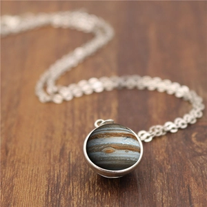 Solar system Jupiter double-sided glass ball pendant necklace with silver chain on wood