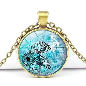 Macro shot of bronze vintage pendant necklace with blue dandelion glass dome detail