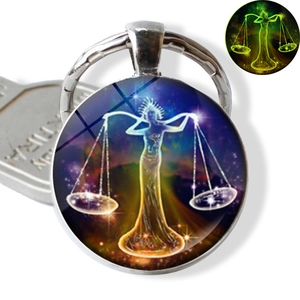 Glow-in-the-dark Libra zodiac sign pendant keychain featuring a purple starry night design