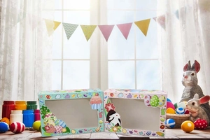 Detailed close-up of Easter gift boxes with bunny prints and clear window on wood