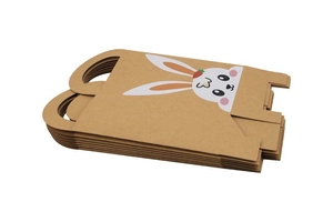 Detail of stacked kraft paper Easter bags with cartoon rabbit ears and strawberry motifs