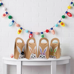 Detail of four Easter bunny kraft gift bags with cartoon ears and festive patterns