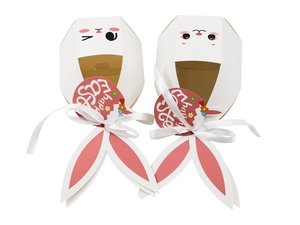 Detailed view of white Easter bunny gift boxes with long ears and silk ribbon bows