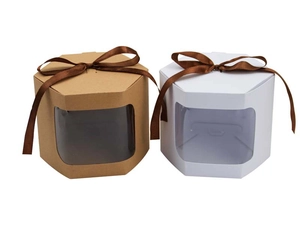 Detail of hexagonal kraft gift box with transparent window and brown satin ribbon bow