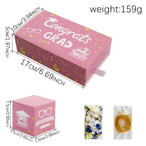 Detail view of pink graduation gift boxes with gold congrats grad text and dimensions