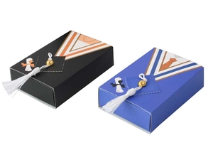 Detail of graduation cap gift boxes in black and blue with elegant silk tassels