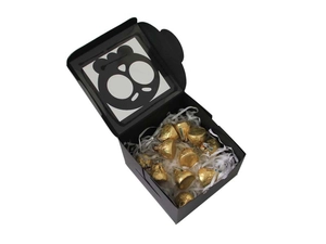 Detail of square black gift box with PVC window featuring cartoon skull and chocolates