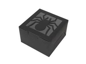 Macro view of square black Halloween gift box with a laser-cut spider pattern lid