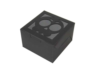 Close-up of black Halloween gift box featuring a laser-cut skull window design