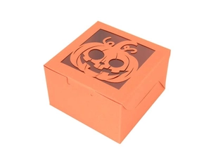 Close-up of orange Halloween gift box with a laser-cut pumpkin window for candy