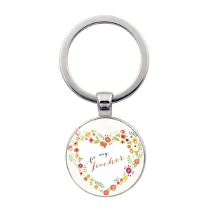 Detail of silver metal keychain with floral heart and 'for my Teacher' text engraving