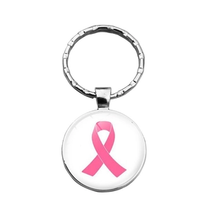Macro view of breast cancer awareness pink ribbon charm with silver metal key ring