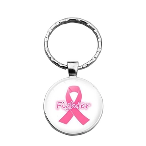 Close-up of silver metal keychain with pink breast cancer ribbon and Fighter text engraving