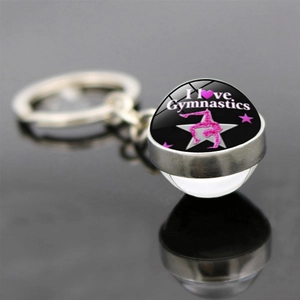 Macro view of double-sided glass pendant keychain with I Love Gymnastics silhouette
