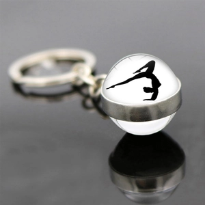 Detailed view of rhythmic gymnastics silhouette inside a clear glass ball keychain