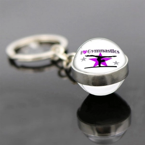 Artistic gymnastics glass ball keychain with purple heart and athlete silhouette design