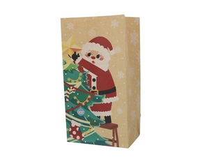 Detailed close-up of a brown kraft paper gift bag with Santa Claus and Christmas tree print