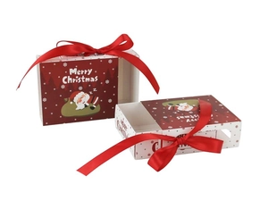 Detail of Christmas drawer gift box with Santa Claus print and red ribbon bow