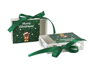Detail of drawer-style Christmas gift box with green ribbon and cartoon reindeer pattern