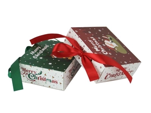 Detail of red and green Christmas drawer gift boxes with silk ribbons and festive patterns