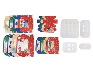 Macro view of Christmas muffin box components with Santa patterns and DIY paper inserts