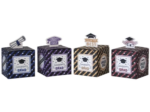 Detail of four graduation candy boxes with tassels and Congrats Grad card inserts