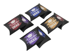 Detail of graduation pillow gift boxes featuring Congrats GRAD text and tassel cap designs