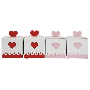 Set of four heart-shaped wedding candy gift boxes with cutout design in red and pink