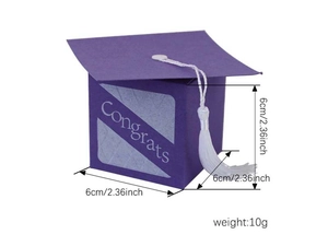Detailed view of purple graduation cap candy box with white tassel and Congrats text