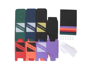 Flat lay of graduation candy boxes showing diverse colors, caps, tassels, and stickers