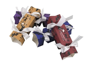 Detail of multi-color graduation candy boxes with satin ribbons and golden lettering