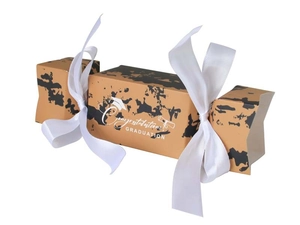 Detail of candy-shaped graduation gift box with marble texture and white silk bows