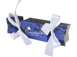 Detail of candy-shaped graduation gift box with marble pattern and white satin ribbons