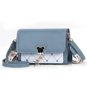 Blue and white quilted crossbody bag with heart embroidery and patterned strap