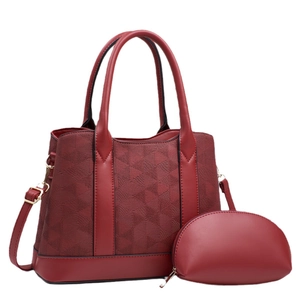 Burgundy textured leather tote and clutch set with geometric embossed pattern details