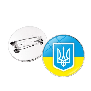 Detail of Ukraine national emblem pin badge with front flag design and silver metal clasp