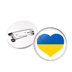 Front and back detail of a silver Ukraine flag heart brooch with pin clasp