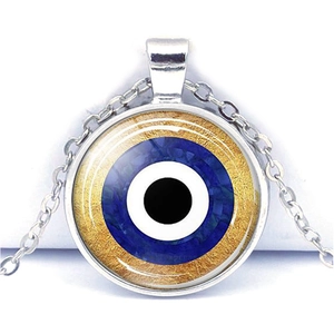 Detail of blue evil eye glass pendant with gold leaf accents on silver chain